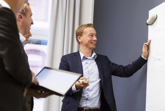 Meeting and showing notes on whiteboard